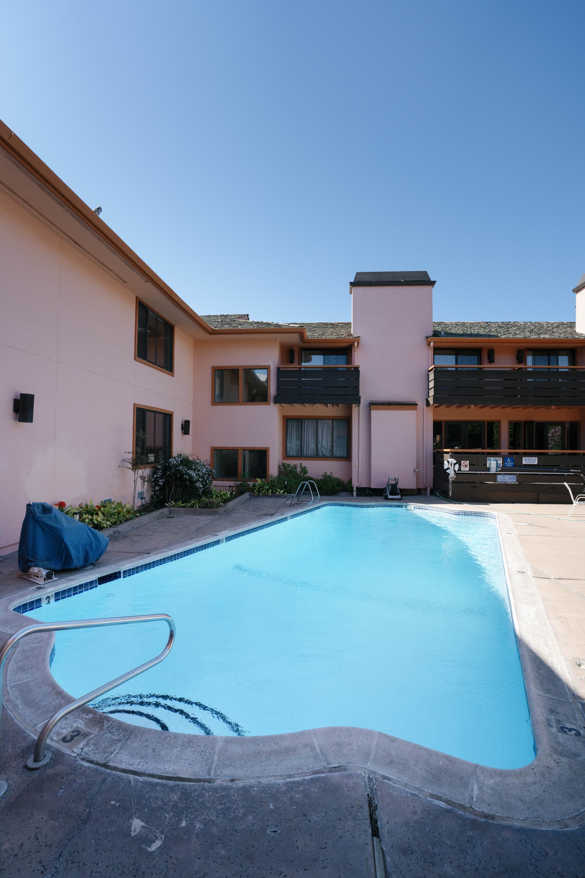 The pool deck at dusk with ambient lighting and fire pits